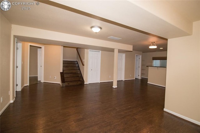 7465 Sun Prairie Dr, Colorado Springs, CO 80925 - unfurnished living room featuring dark wood-style floors and stairs