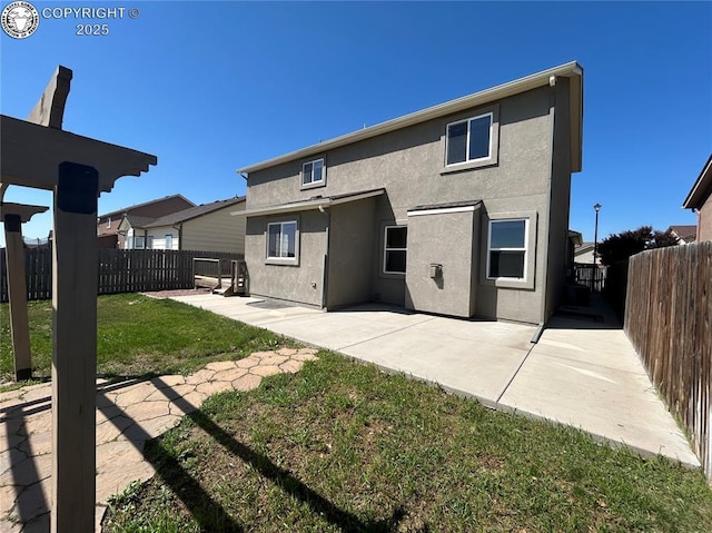 7465 Sun Prairie Dr, Colorado Springs, CO 80925 - back of house with stucco siding, a patio area, and a fenced backyard