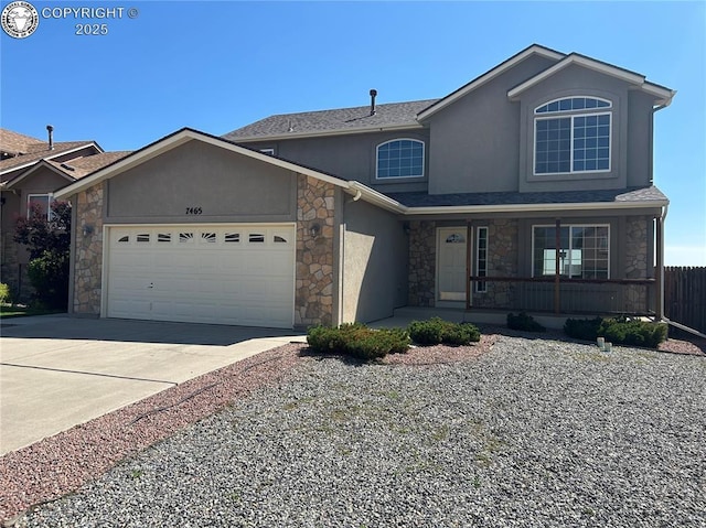 7465 Sun Prairie Dr, Colorado Springs, CO 80925 - traditional-style house with stone siding, stucco siding, an attached garage, a porch, and driveway