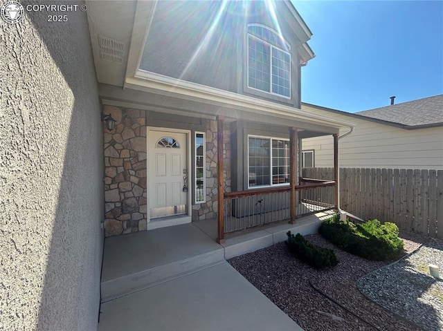 7465 Sun Prairie Dr, Colorado Springs, CO 80925 - view of exterior entry featuring covered porch and stone siding