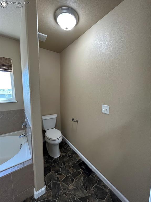 7465 Sun Prairie Dr, Colorado Springs, CO 80925 - full bath with a bath and a textured ceiling