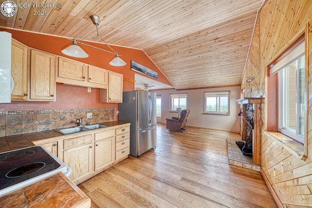 421 Bull Domingo Ln, Westcliffe, CO 81252 - kitchen with freestanding refrigerator, light brown cabinetry, tile counters, wood ceiling, and light wood-type flooring