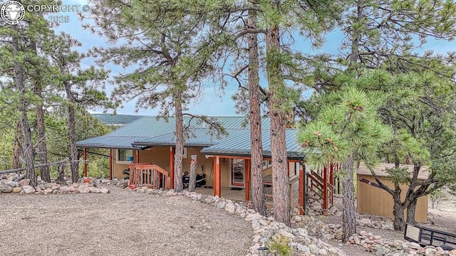 421 Bull Domingo Ln, Westcliffe, CO 81252 - back of house with a porch, a metal roof, and stucco siding