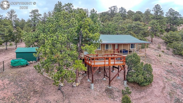 421 Bull Domingo Ln, Westcliffe, CO 81252 - back of house with a metal roof, a forest view, and covered porch