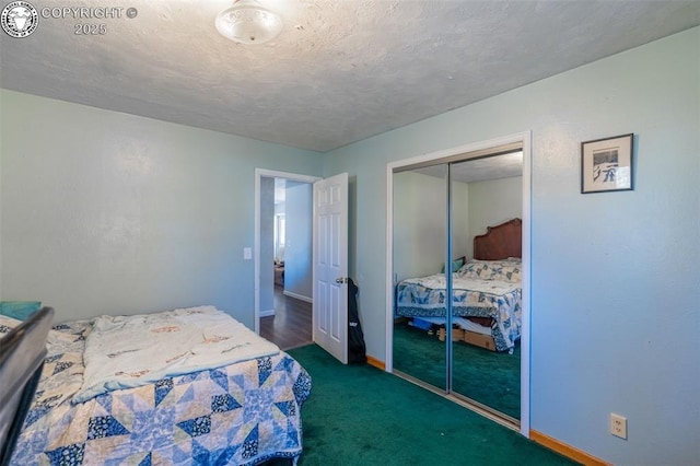 carpeted bedroom with a closet, baseboards, and a textured ceiling