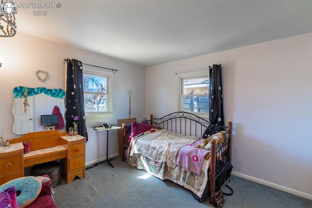 carpeted bedroom with multiple windows and baseboards