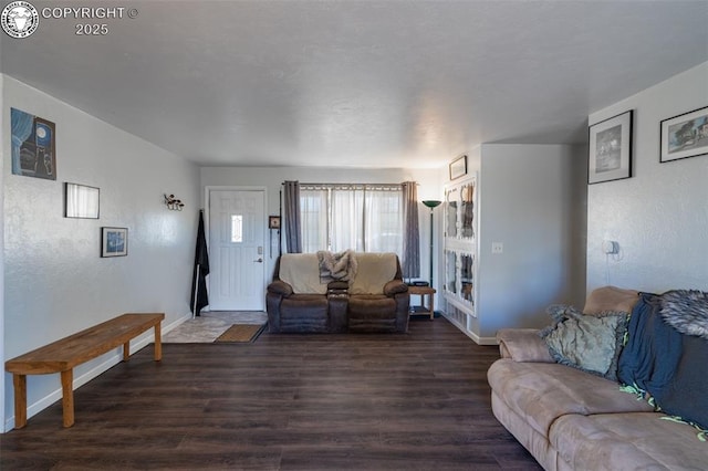 living area featuring baseboards and wood finished floors