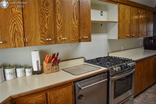 kitchen with range with gas cooktop, stainless steel refrigerator with ice dispenser, lofted ceiling, light countertops, and brown cabinetry