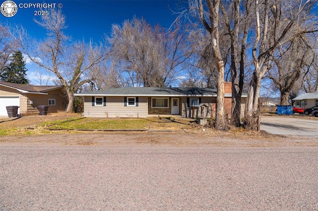 ranch-style home with a garage and a front lawn