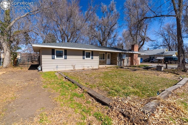 single story home featuring fence, a chimney, and a front lawn