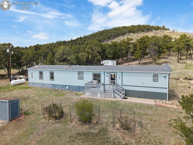 2275 K Path, Cotopaxi, CO 81223 - view of front of home featuring a shingled roof, a forest view, and crawl space