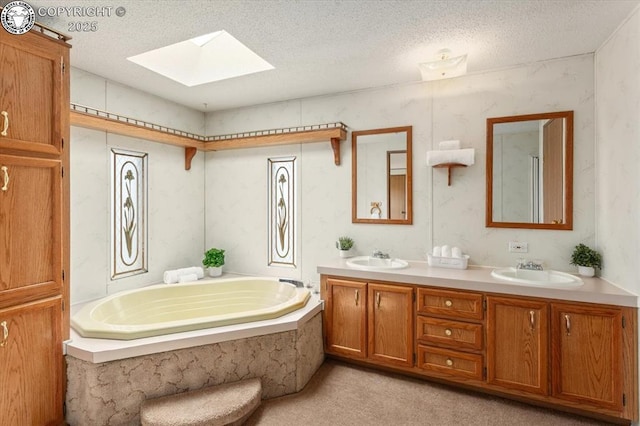 2275 K Path, Cotopaxi, CO 81223 - full bathroom featuring a skylight, double vanity, a garden tub, and a textured ceiling
