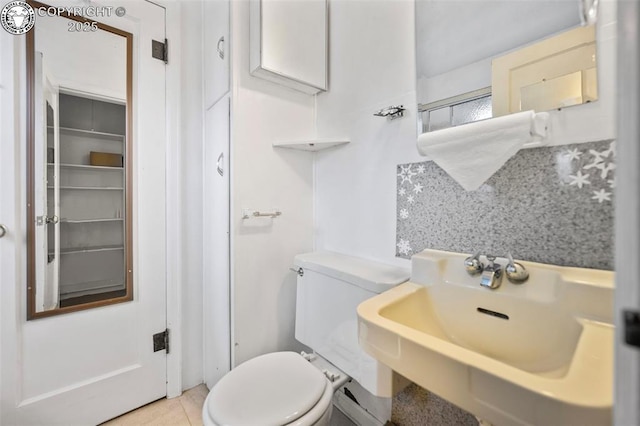 bathroom featuring tile patterned flooring, a sink, and toilet