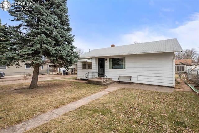 view of front of property with fence and a front yard