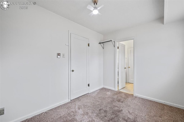 unfurnished bedroom with carpet flooring, ceiling fan, and baseboards