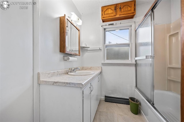 full bathroom featuring combined bath / shower with glass door, vanity, a textured ceiling, and tile patterned floors