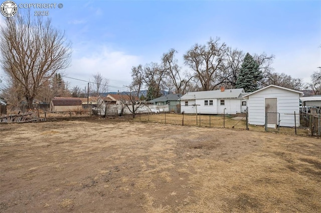 view of yard featuring a storage unit, fence, and an outdoor structure