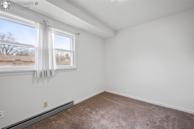 carpeted empty room with a baseboard heating unit and baseboards