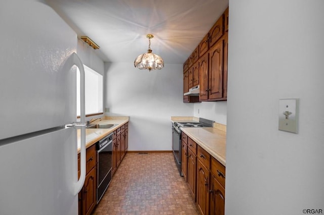 kitchen with pendant lighting, sink, dishwasher, white refrigerator, and stainless steel range with electric cooktop