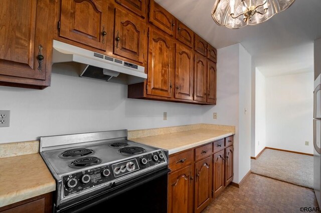 kitchen with black electric range oven and a notable chandelier