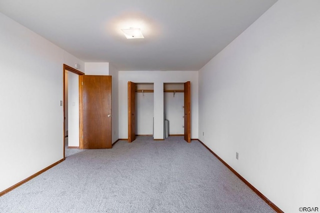 unfurnished bedroom featuring light colored carpet and a closet