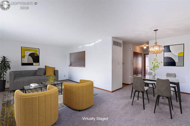 living room with an inviting chandelier and carpet