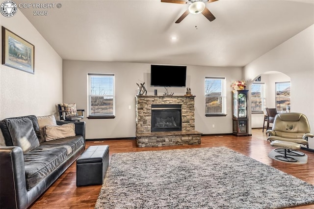 living room with ceiling fan, dark hardwood / wood-style floors, and a fireplace