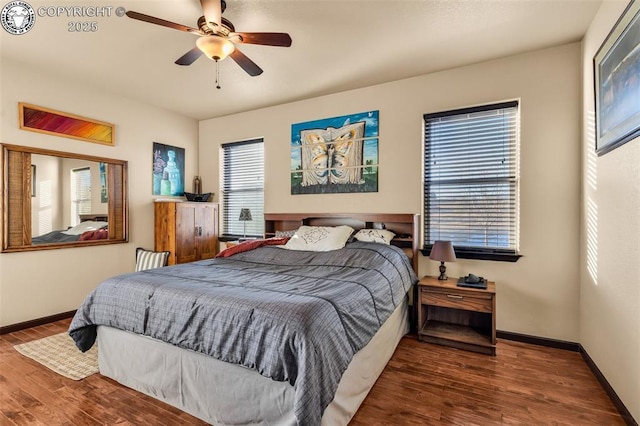 bedroom with ceiling fan and dark hardwood / wood-style flooring