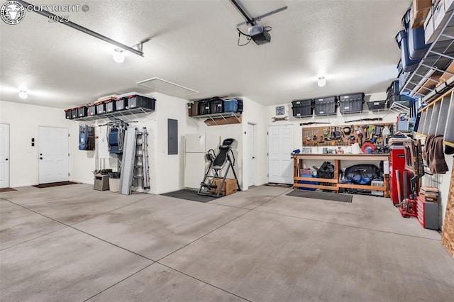 garage with a garage door opener, electric panel, a workshop area, and white refrigerator