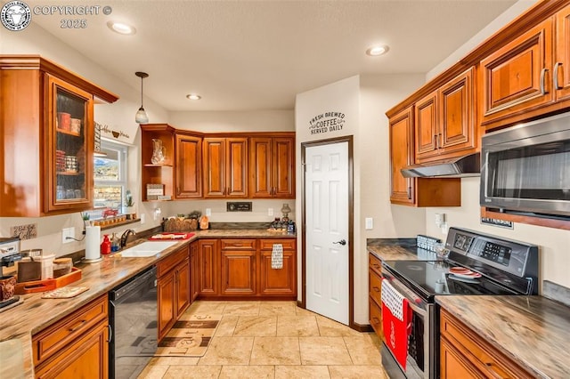 kitchen featuring sink, light stone countertops, hanging light fixtures, and appliances with stainless steel finishes