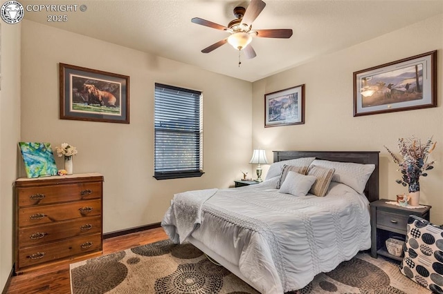 bedroom with light hardwood / wood-style floors and ceiling fan