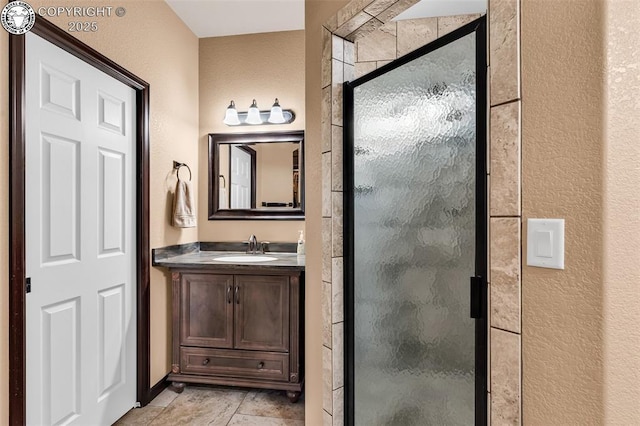 bathroom with vanity and a shower with shower door