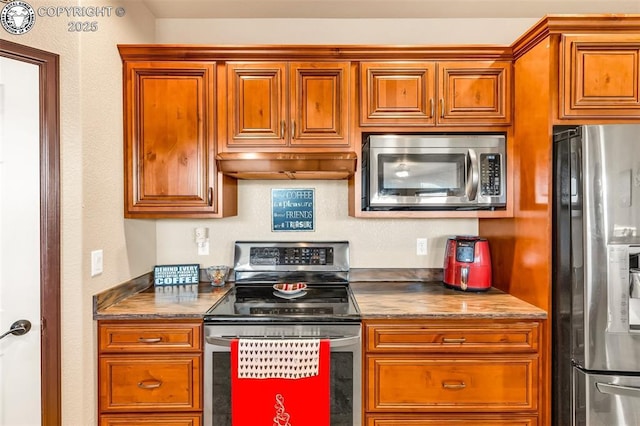 kitchen featuring appliances with stainless steel finishes and extractor fan