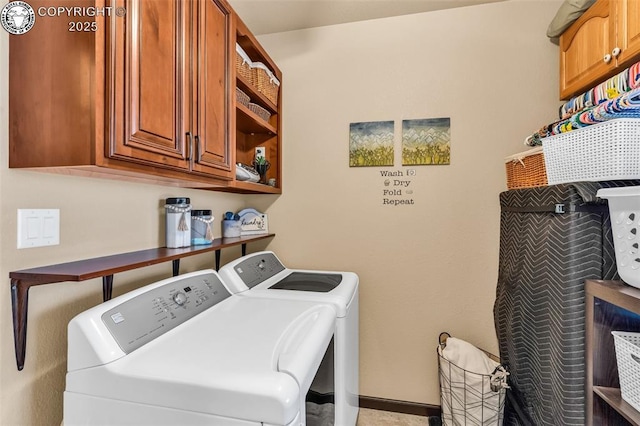 laundry room featuring cabinets and separate washer and dryer