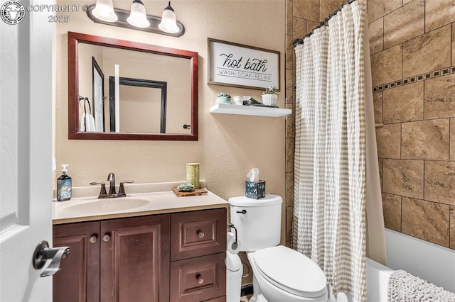 full bathroom with vanity, shower / bath combo, and toilet