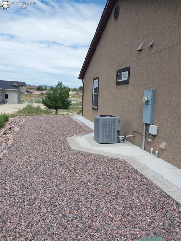 exterior space with a patio and central air condition unit