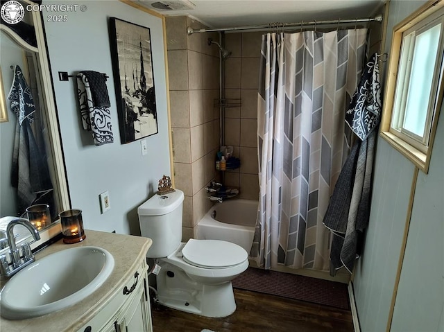 full bathroom with shower / tub combo, hardwood / wood-style floors, vanity, and toilet