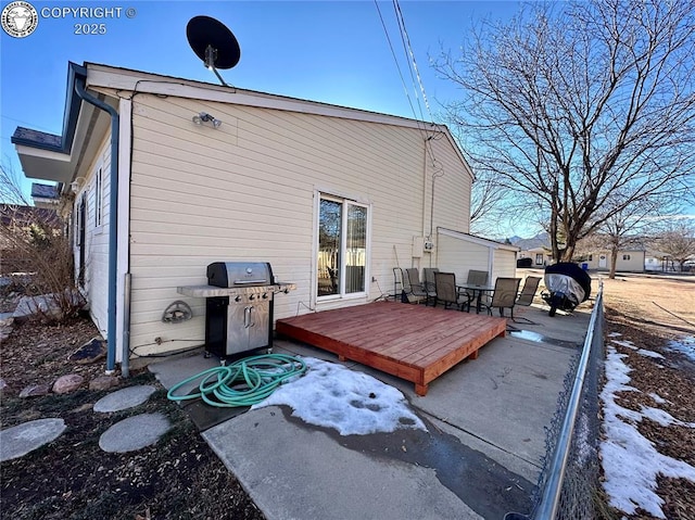 rear view of property featuring a wooden deck