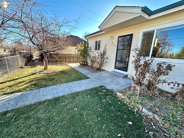 entrance to property featuring a yard