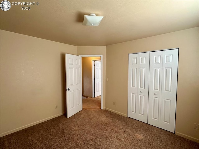 unfurnished bedroom featuring carpet floors and a closet