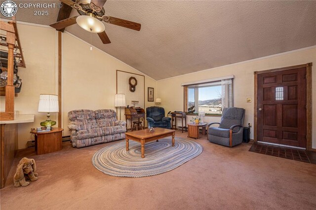 living room featuring lofted ceiling, ceiling fan, a textured ceiling, and carpet flooring