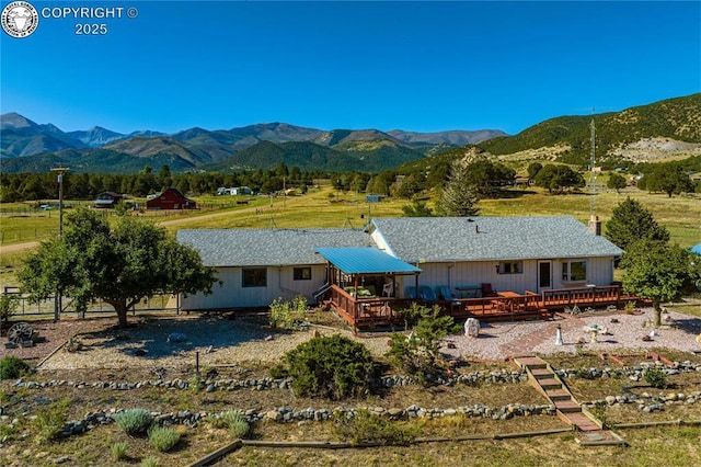 back of house featuring a deck with mountain view