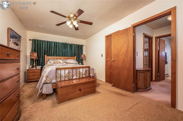 carpeted bedroom featuring ceiling fan and a textured ceiling