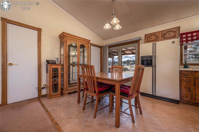 tiled dining room featuring lofted ceiling, a notable chandelier, and a textured ceiling