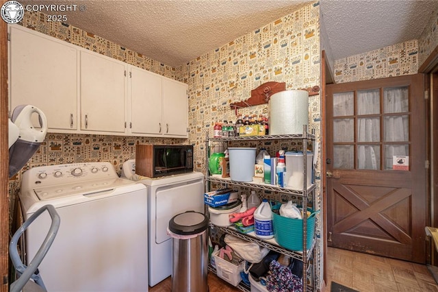 washroom featuring cabinets, dark parquet floors, washing machine and dryer, and a textured ceiling