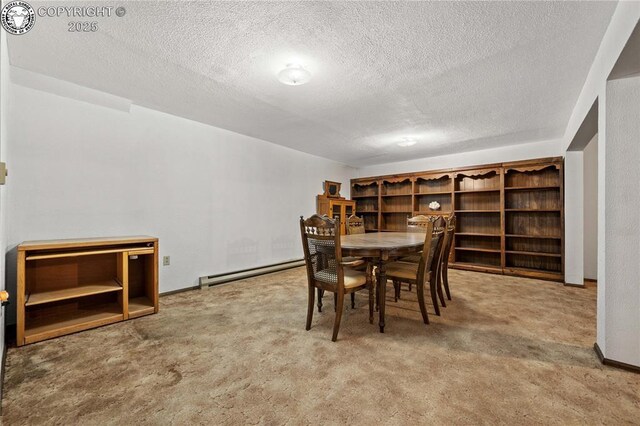 carpeted dining room featuring a textured ceiling and a baseboard heating unit