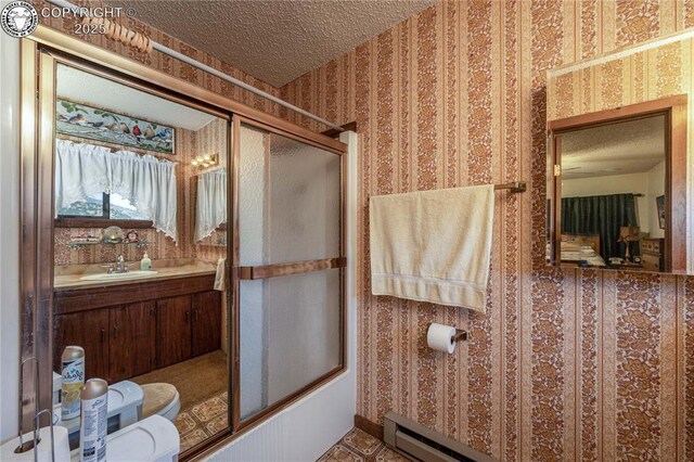 bathroom with vanity, a baseboard radiator, and combined bath / shower with glass door