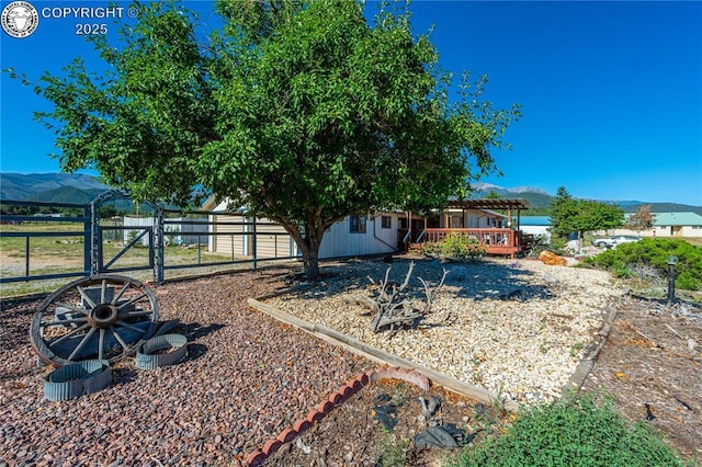 view of yard featuring a deck with mountain view