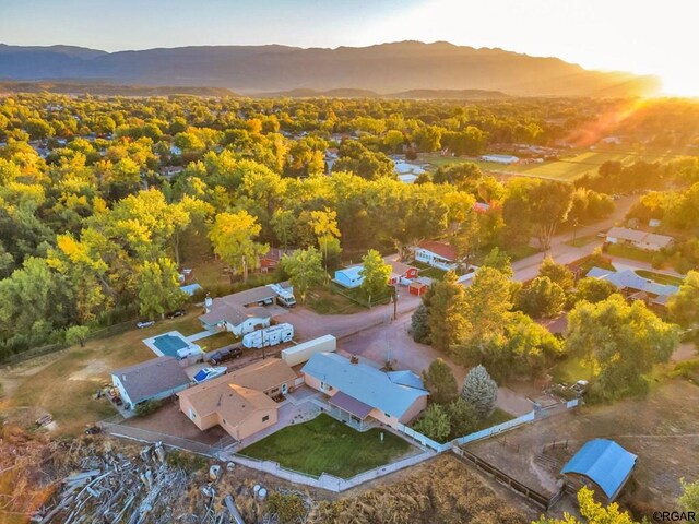 aerial view at dusk featuring a mountain view