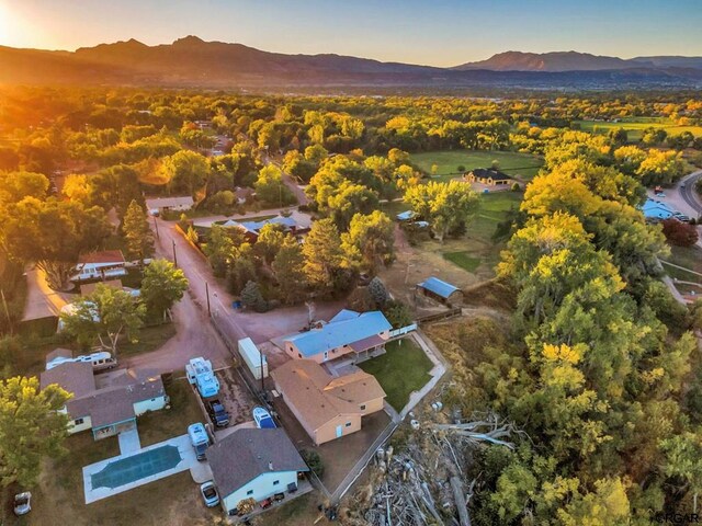 aerial view at dusk featuring a mountain view